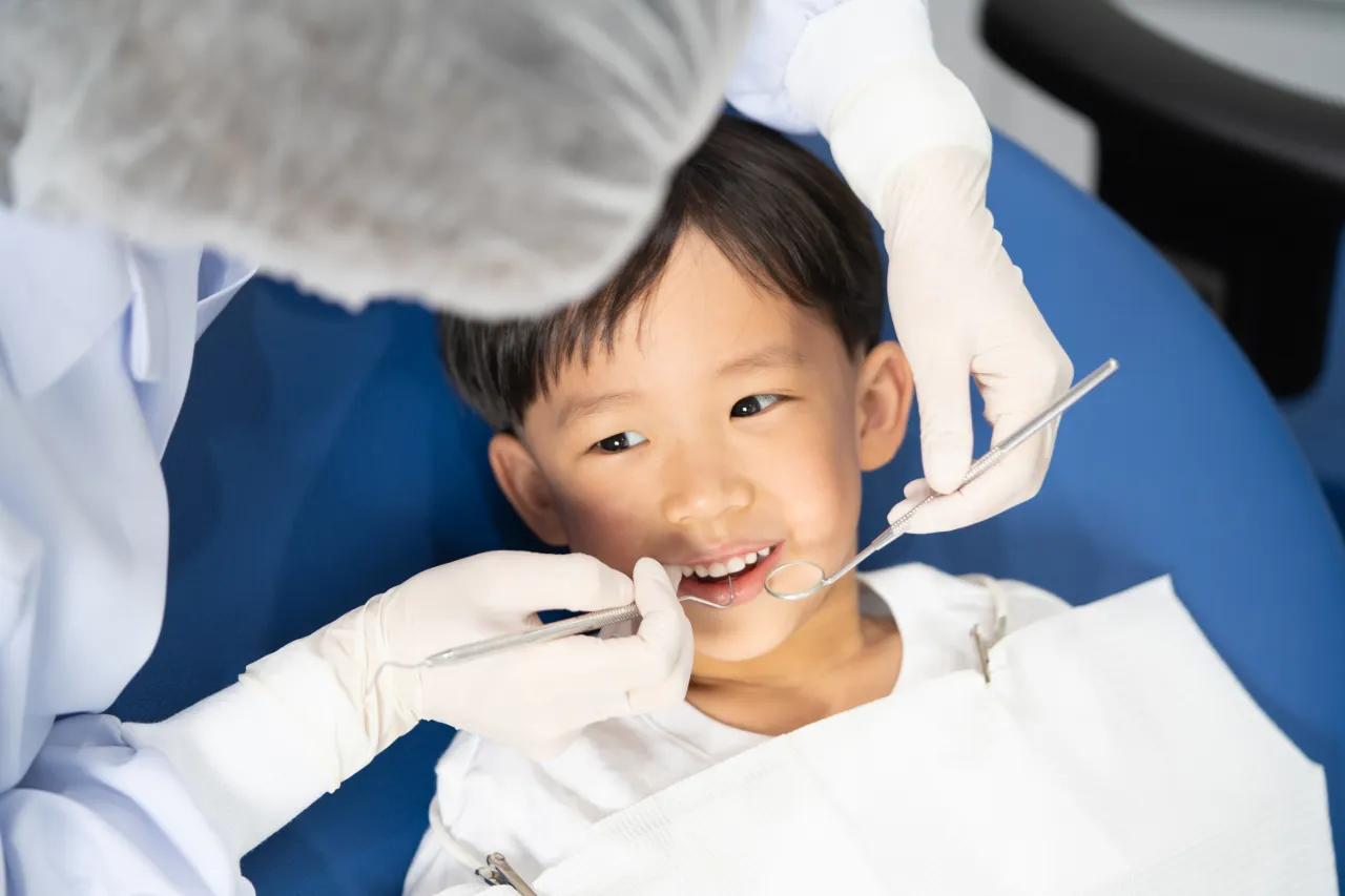 Boy undergoing an orthodontic assessment with a child dentist 